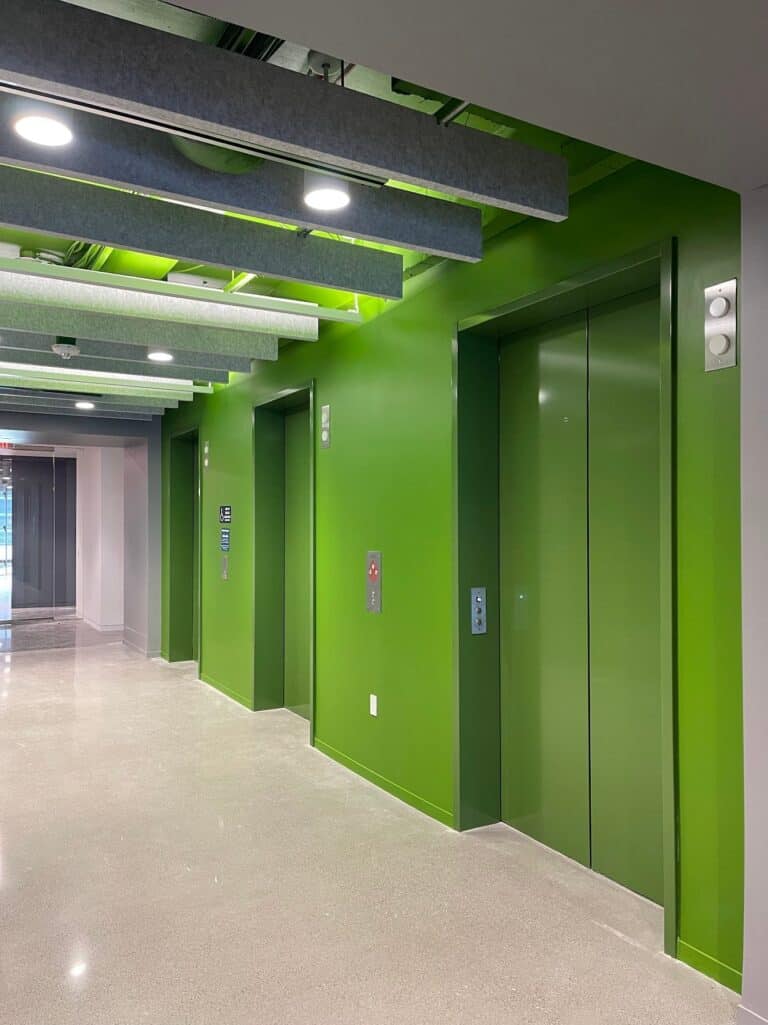 Commercial elevator lobby painted bright green