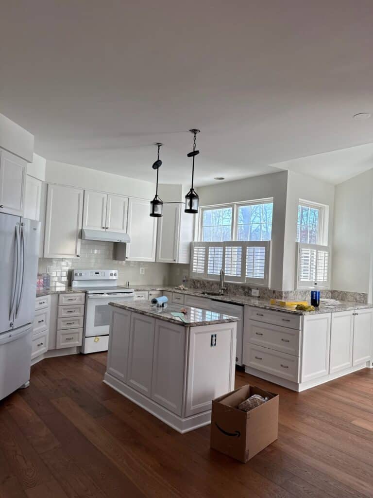Cabinet paint refinishing: white painted kitchen cabinets and island